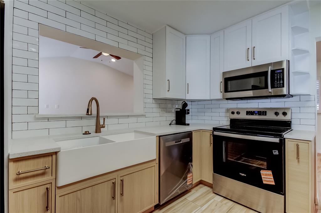 3936 East Eden Roc Circle Tampa, FL 33634 - Photo 19 of 68 a kitchen with cabinets stainless steel appliances and a sink