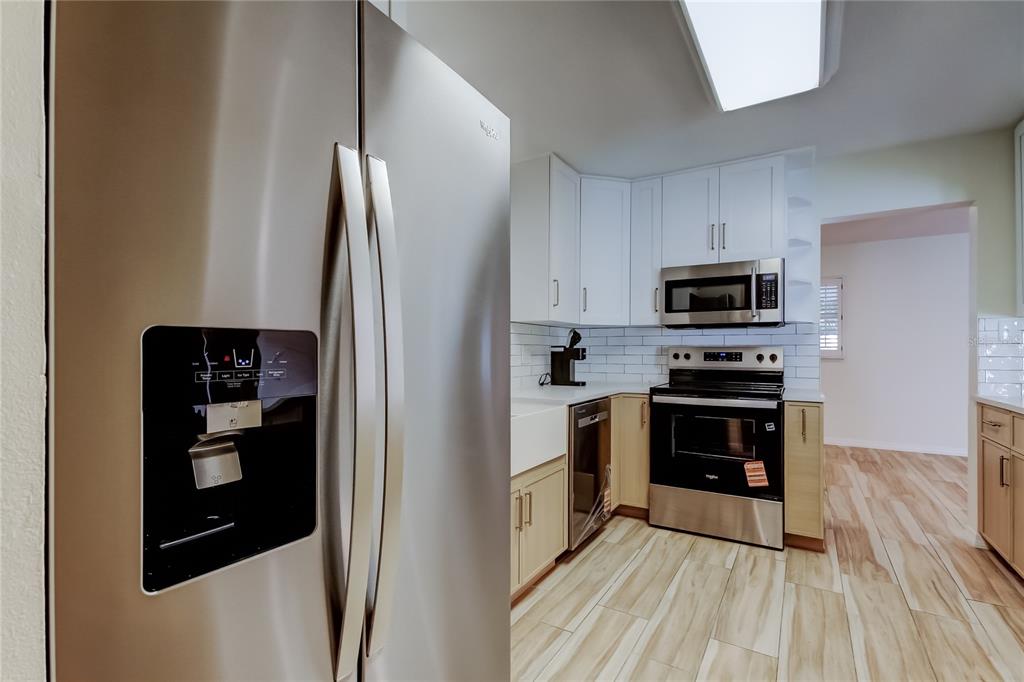 3936 East Eden Roc Circle Tampa, FL 33634 - Photo 20 of 68 a kitchen with stainless steel appliances a refrigerator stove and microwave