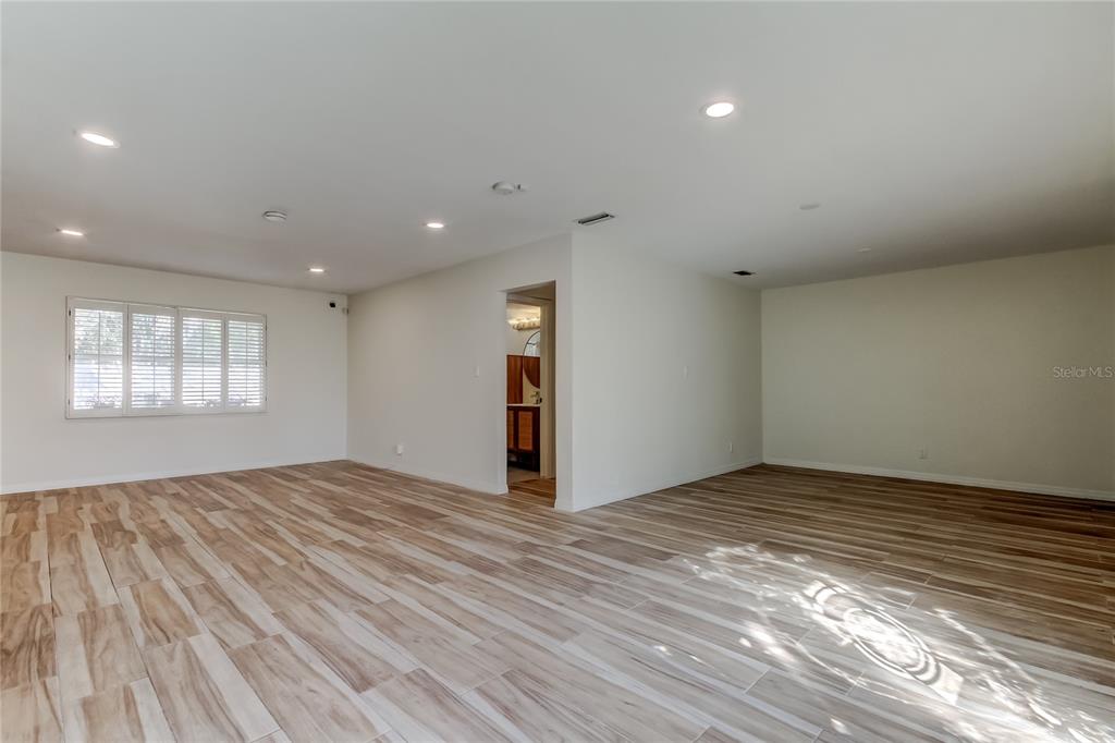 3936 East Eden Roc Circle Tampa, FL 33634 - Photo 2 of 68 a view of an empty room with wooden floor and a window
