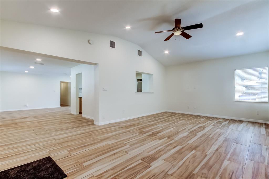 3936 East Eden Roc Circle Tampa, FL 33634 - Photo 26 of 68 a view of a livingroom with a hall and wooden floor