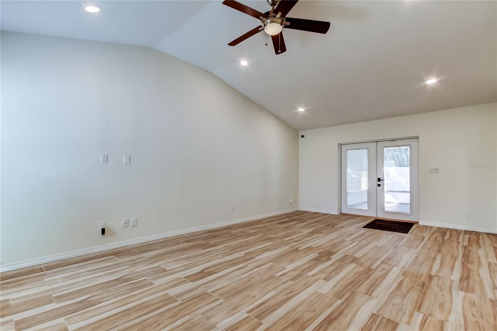 3936 East Eden Roc Circle Tampa, FL 33634 - Photo 28 of 68 a view of a livingroom with a ceiling fan and wooden floor