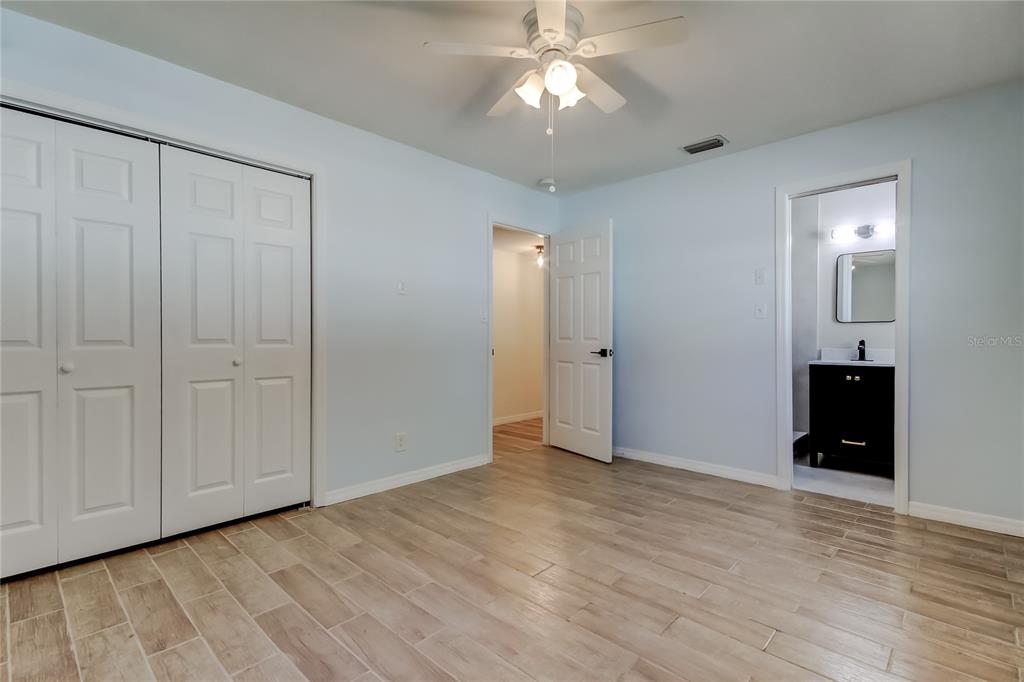 3936 East Eden Roc Circle Tampa, FL 33634 - Photo 34 of 68 a view of an empty room with wooden floor