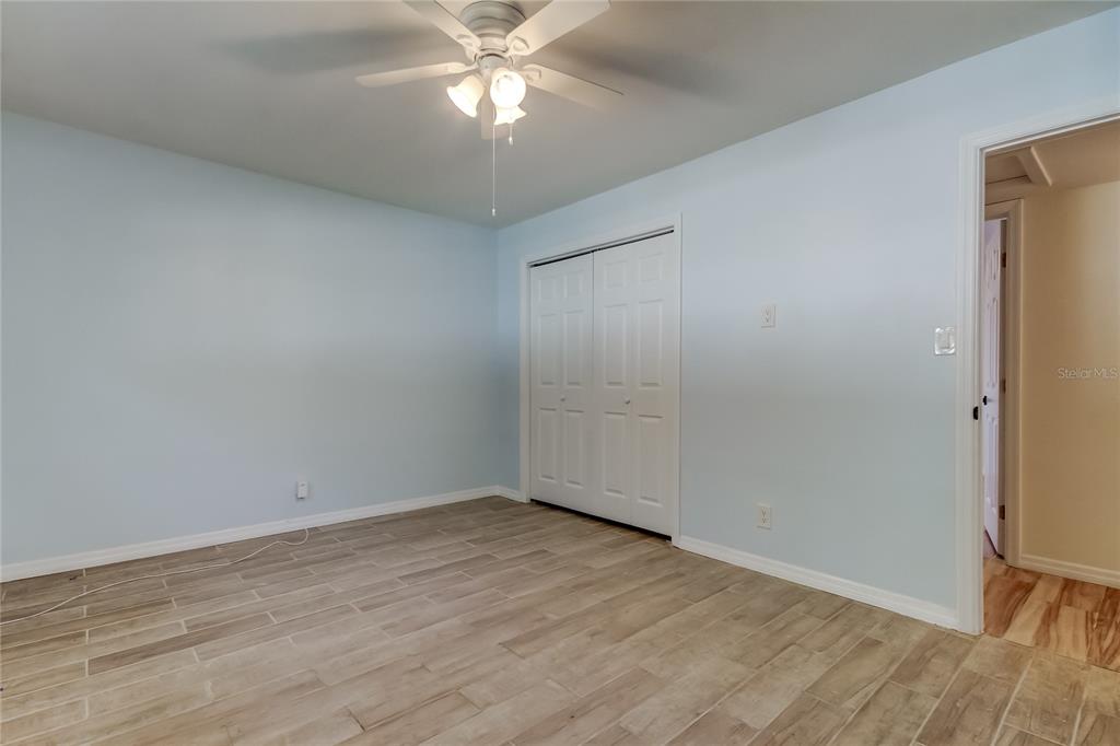 3936 East Eden Roc Circle Tampa, FL 33634 - Photo 35 of 68 a view of an empty room with wooden floor