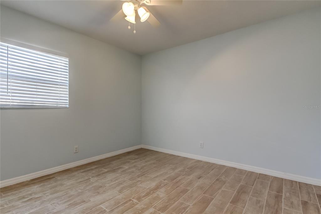 3936 East Eden Roc Circle Tampa, FL 33634 - Photo 38 of 68 wooden floor in an empty room with a window