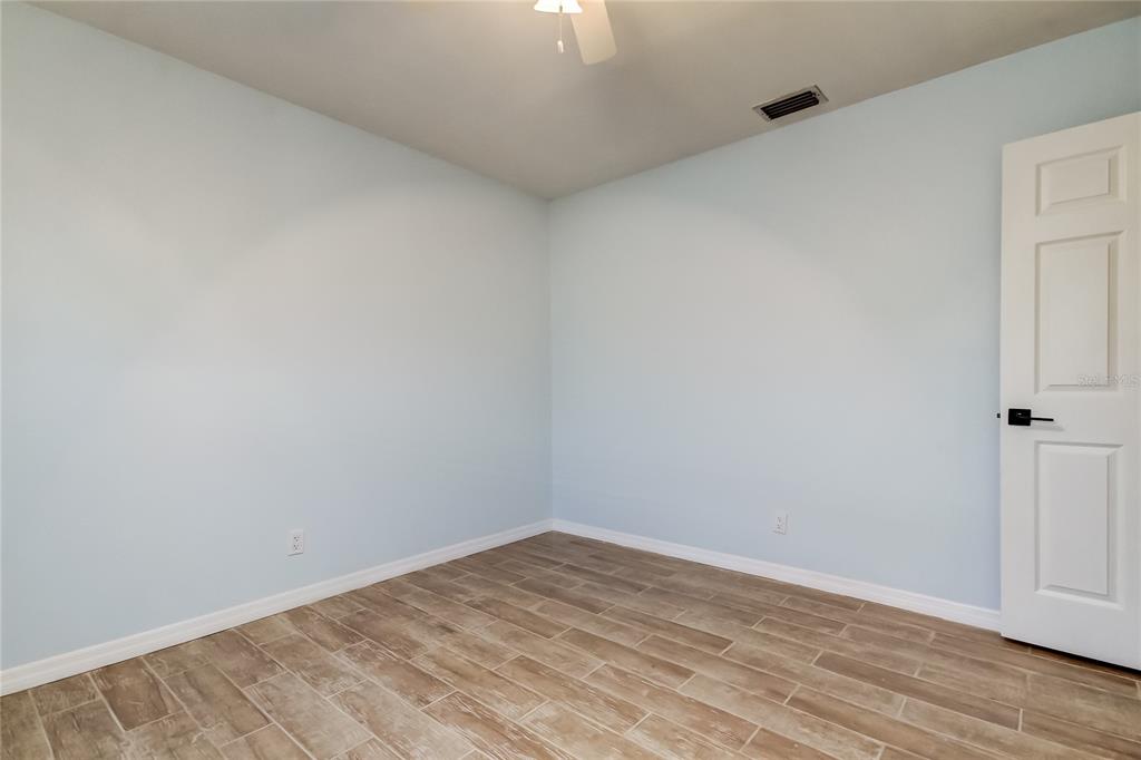 3936 East Eden Roc Circle Tampa, FL 33634 - Photo 41 of 68 a view of empty room with wooden floor