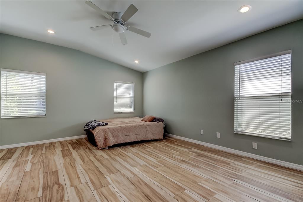 3936 East Eden Roc Circle Tampa, FL 33634 - Photo 46 of 68 a spacious bedroom with a bed and a window