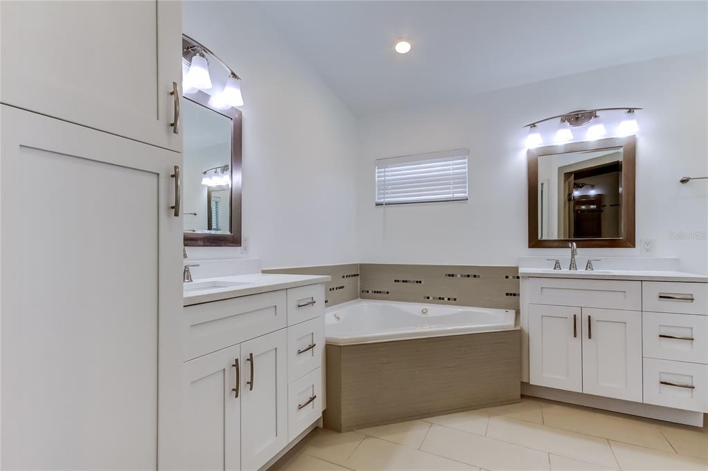 3936 East Eden Roc Circle Tampa, FL 33634 - Photo 50 of 68 a bathroom with a sink double vanity and a mirror