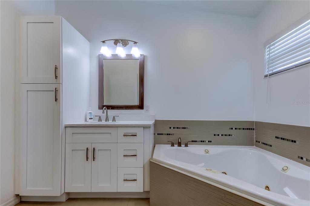 3936 East Eden Roc Circle Tampa, FL 33634 - Photo 51 of 68 a bathroom with a sink and a mirror
