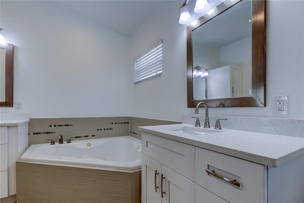 3936 East Eden Roc Circle Tampa, FL 33634 - Photo 52 of 68 a bathroom with a sink and a mirror