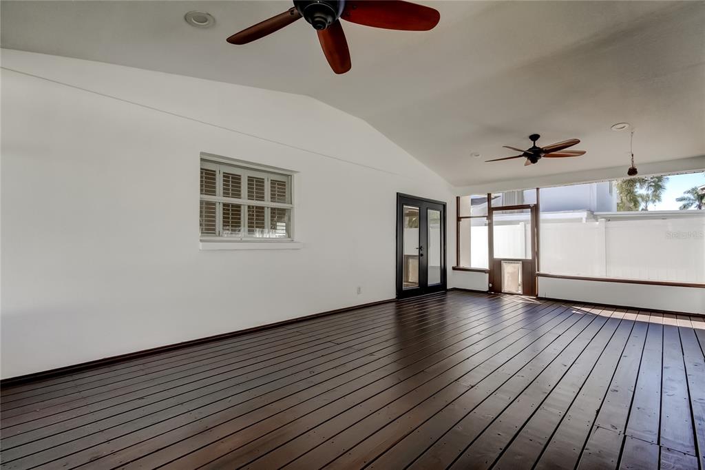 3936 East Eden Roc Circle Tampa, FL 33634 - Photo 58 of 68 a view of an empty room with a window and wooden floor