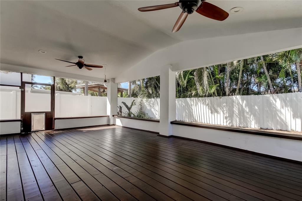 3936 East Eden Roc Circle Tampa, FL 33634 - Photo 59 of 68 an empty room with wooden floor fan and windows
