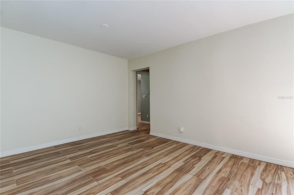 3936 East Eden Roc Circle Tampa, FL 33634 - Photo 6 of 68 a view of an empty room with wooden floor and a window