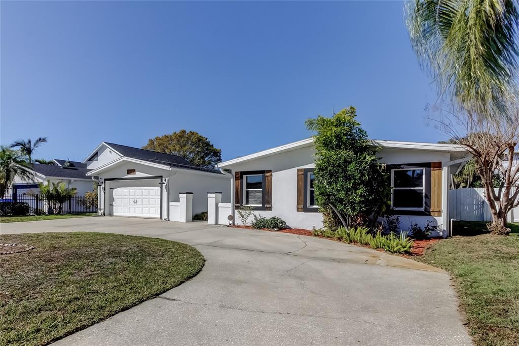 3936 East Eden Roc Circle Tampa, FL 33634 - Photo 67 of 68 front view of a house with a yard