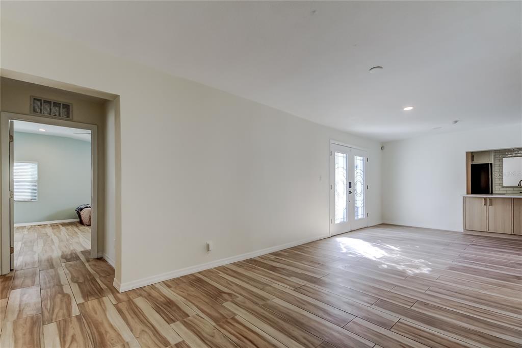 3936 East Eden Roc Circle Tampa, FL 33634 - Photo 7 of 68 a view of a big room with wooden floor and windows