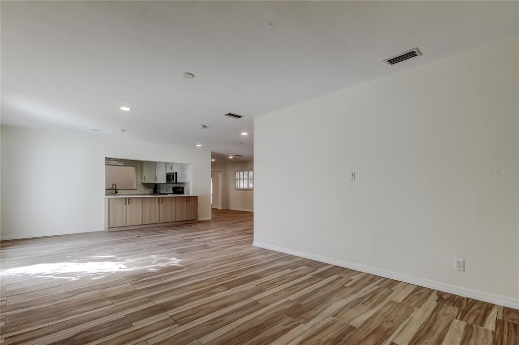 3936 East Eden Roc Circle Tampa, FL 33634 - Photo 8 of 68 a kitchen with granite countertop a stove and cabinets