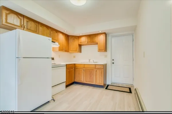 a kitchen with a refrigerator and a sink