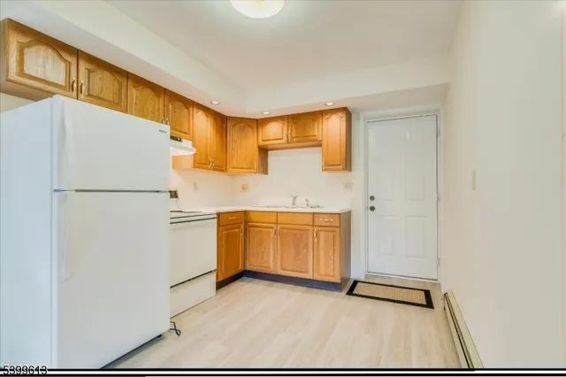 a kitchen with a refrigerator and a sink