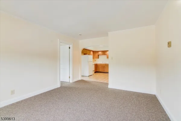 a view of a livingroom with a kitchen and a sink