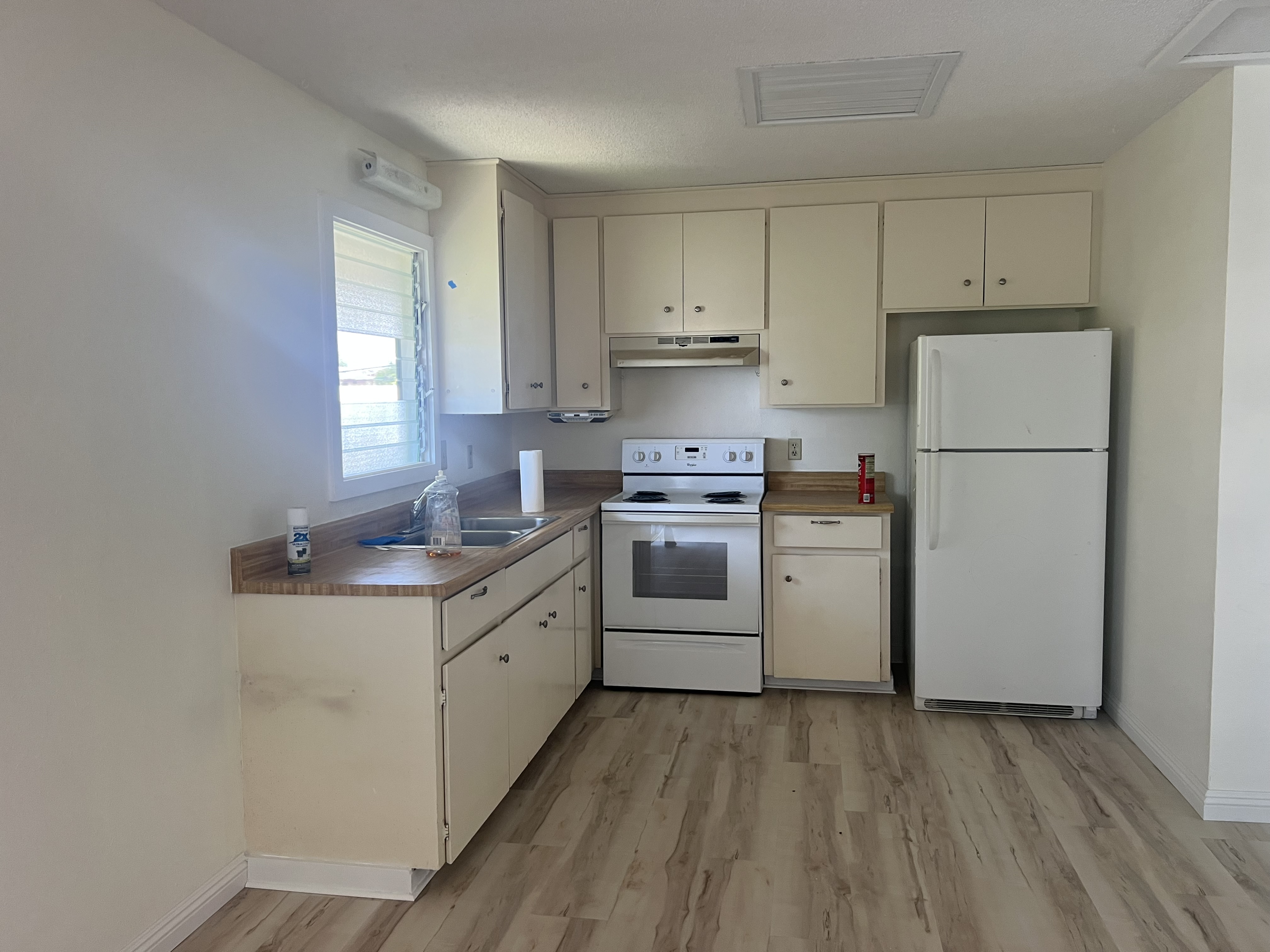 75-185-b Alakai Street, Unit B Kailua-Kona, HI 96740 - Photo 23 of 27 a kitchen with white cabinets and white appliances