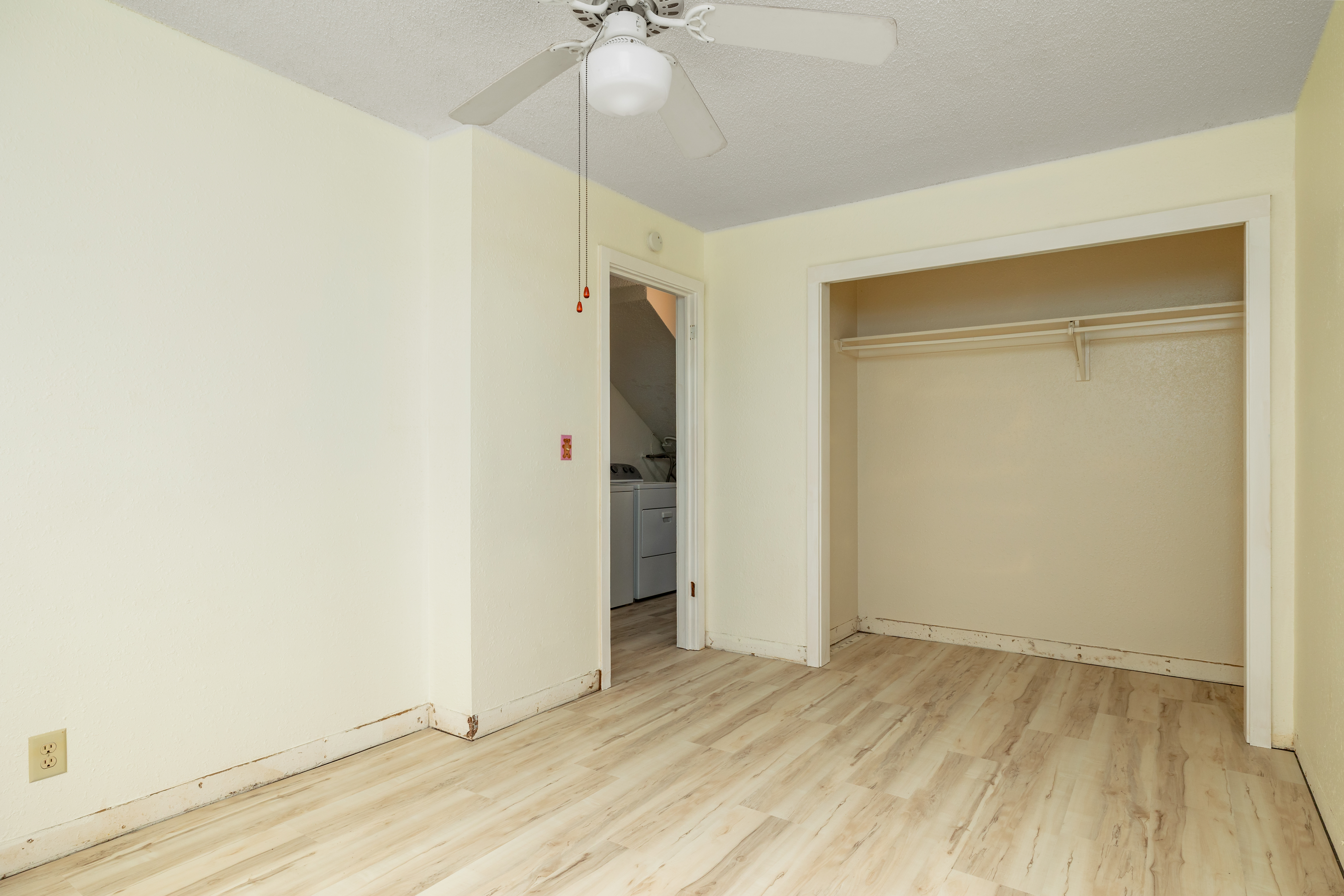 75-185-b Alakai Street, Unit B Kailua-Kona, HI 96740 - Photo 8 of 27 an empty room with wooden floor and ceiling fan