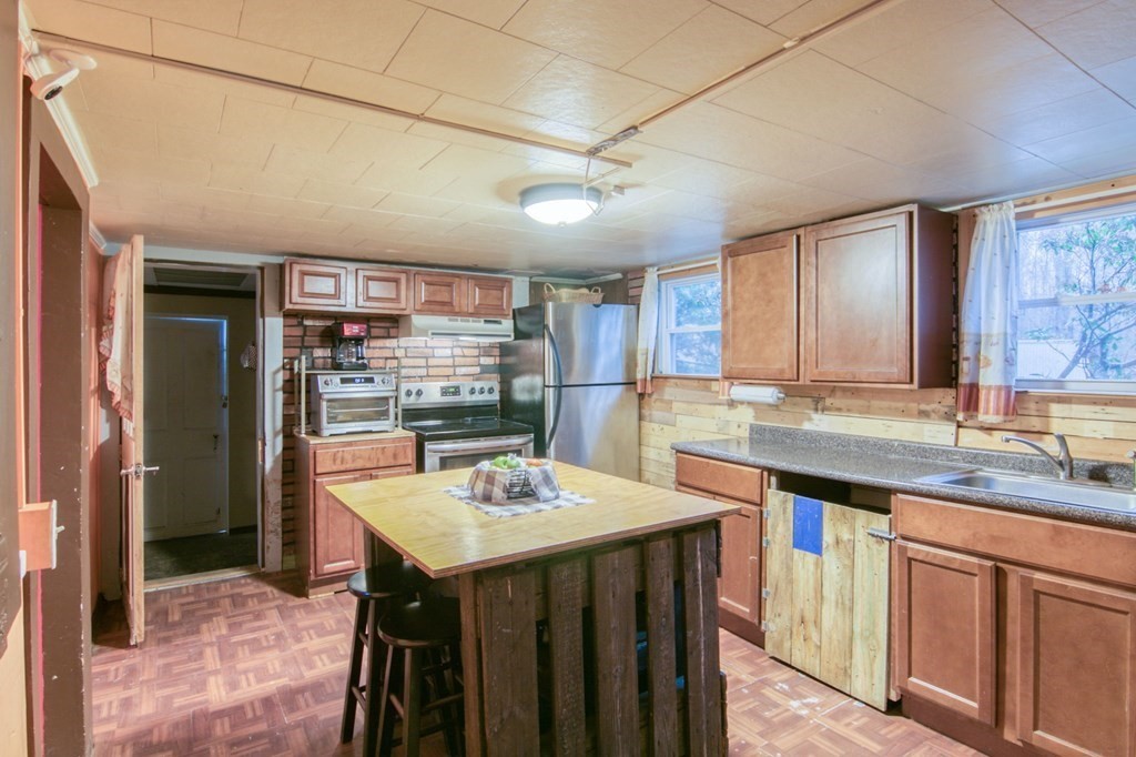 2 Three Rivers Road Wilbraham, MA 01095 - Photo 4 of 25 a kitchen with a sink a center island and cabinets