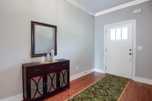 a view of an entryway with table and mirror