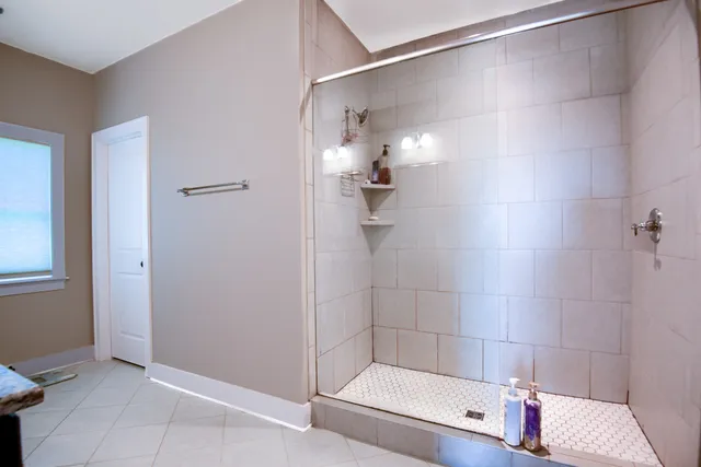 a bathroom with a shower and a tub