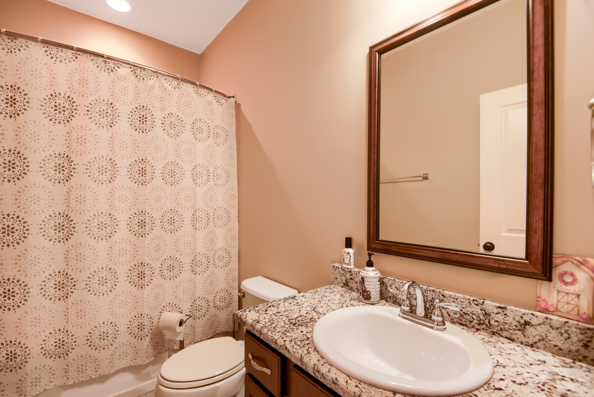 4019 Ryecroft Lane Franklin, TN 37064 - Photo 19 of 35 a bathroom with a sink a toilet and shower curtain