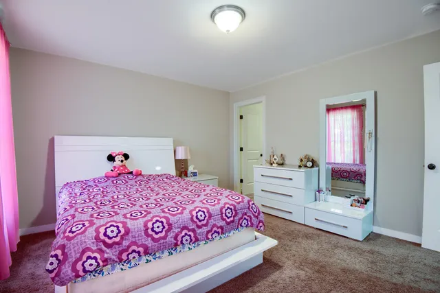 a bedroom with a bed and a dresser