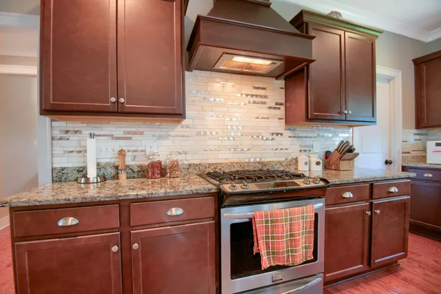 a kitchen with granite countertop stainless steel appliances and wooden cabinets