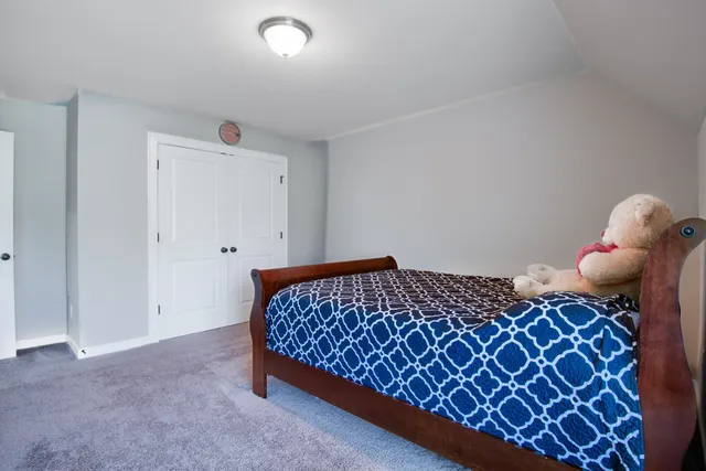 a bedroom with a bed and couch