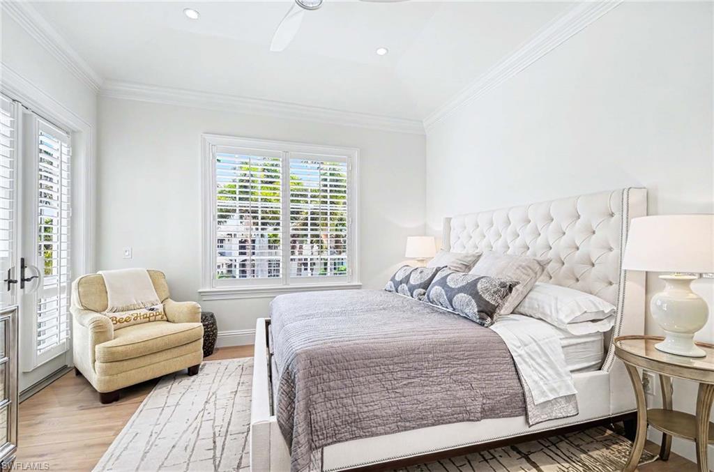 1888 6th Street South Naples, FL 34102 - Photo 29 of 37 a bedroom with a bed and wooden floor