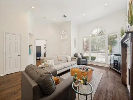 a living room with fireplace furniture and a large window