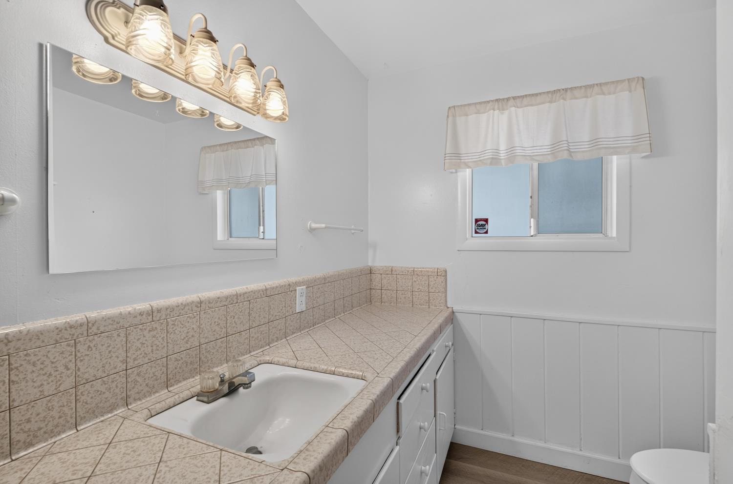 10700 Calvine Road Elk Grove, CA 95830 - Photo 34 of 73 a bathroom with a sink vanity and toilet