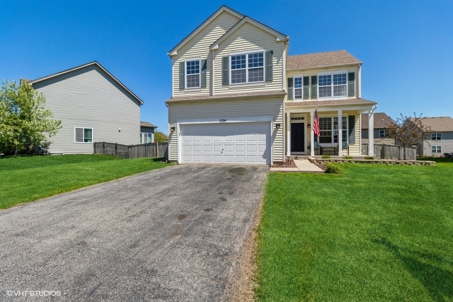 a front view of a house with a yard and garage