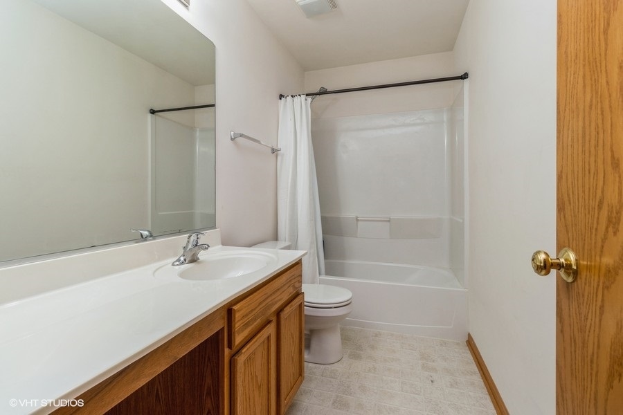 1504 Kempton Street Joliet, IL 60431 - Photo 12 of 15 a bathroom with a sink a toilet and shower