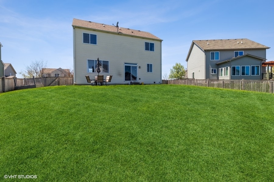 1504 Kempton Street Joliet, IL 60431 - Photo 14 of 15 a view of a house with backyard and porch