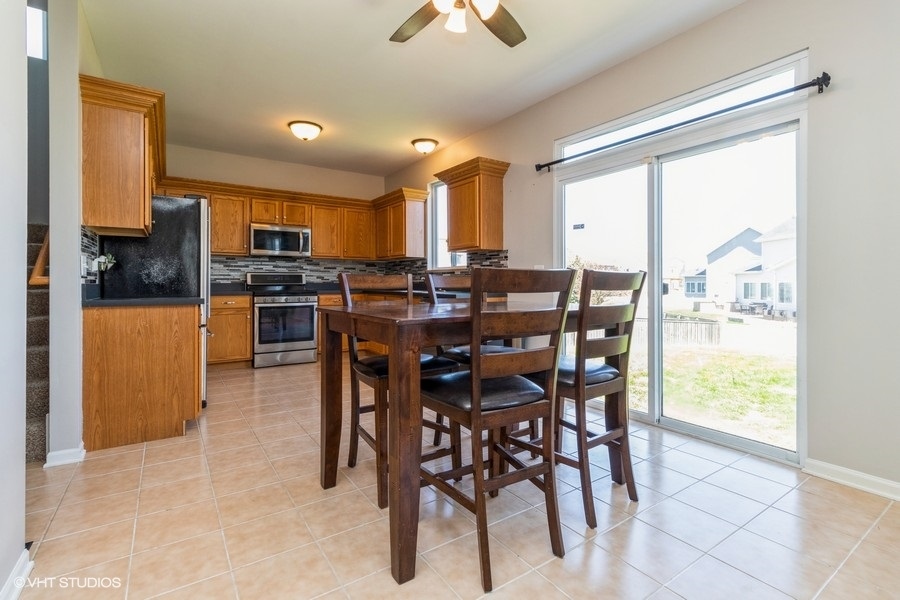 1504 Kempton Street Joliet, IL 60431 - Photo 6 of 15 a view of a dining room with furniture window and outside view