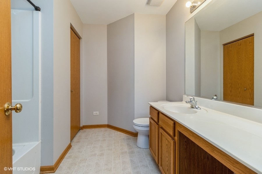 1504 Kempton Street Joliet, IL 60431 - Photo 8 of 15 a bathroom with a sink a toilet and shower