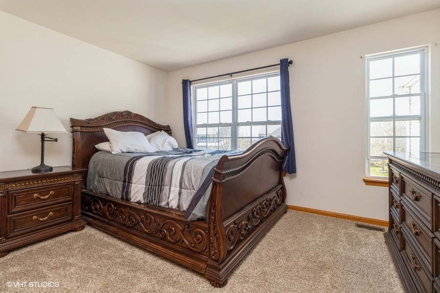 1504 Kempton Street Joliet, IL 60431 - Photo 10 of 15 a bed room with a bed and a window