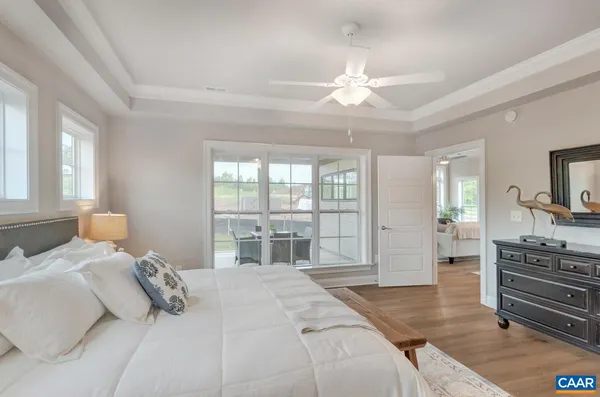 a bedroom with a large bed and flat tv