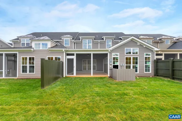a view of a house with yard and porch with a barbeque grill