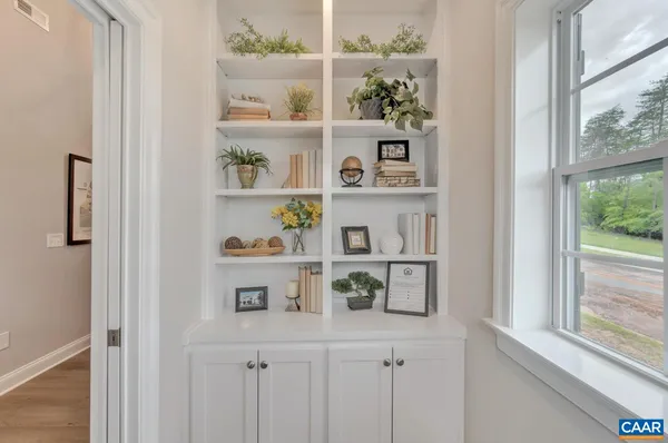 a shelf with books and knick knacks on it