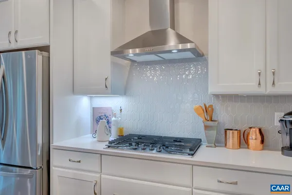 a kitchen with stainless steel appliances granite countertop a stove a refrigerator and cabinets