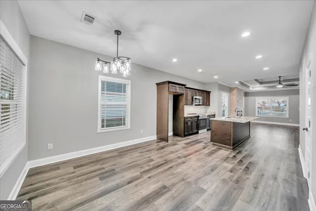 a view of kitchen with cabinets and wooden floor