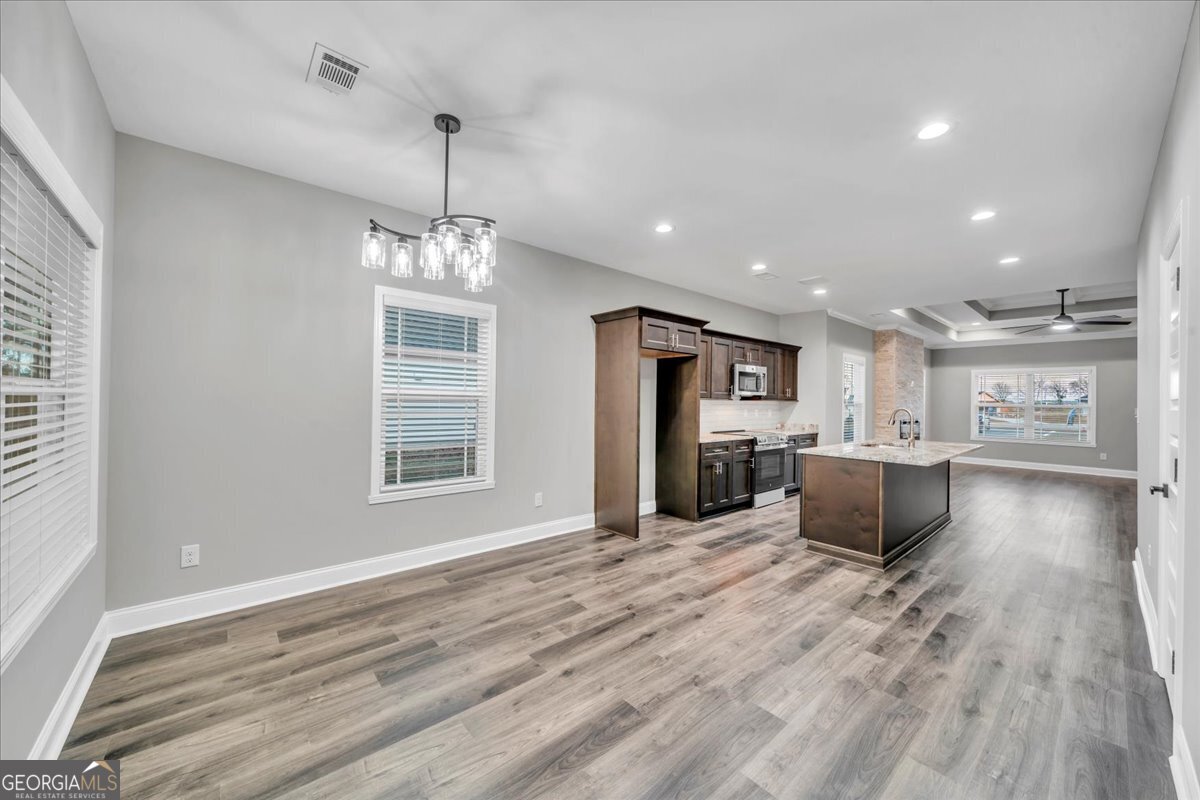 212 Eric Court Byron, GA 31008 - Photo 14 of 37 a view of kitchen with cabinets and wooden floor