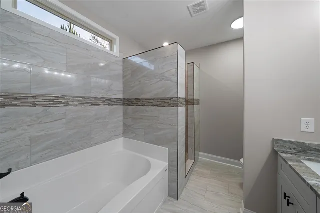 a bathroom with a bathtub and a shower