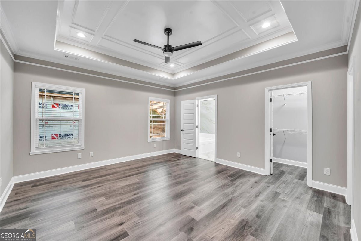 212 Eric Court Byron, GA 31008 - Photo 17 of 37 a view of an empty room with a window and wooden floor