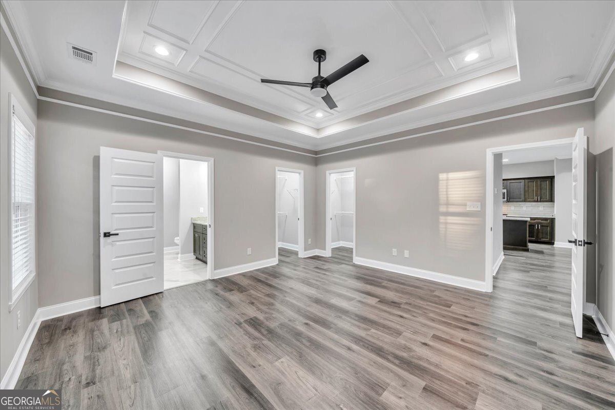 212 Eric Court Byron, GA 31008 - Photo 18 of 37 a view of an empty room with wooden floor and a window