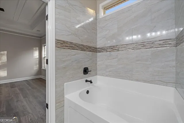 a bathroom with a bathtub and shower